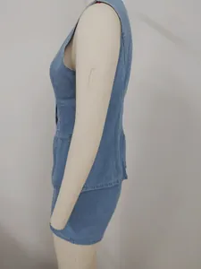 Side view of a washed blue denim sleeveless vest and matching bottom set on a mannequin.