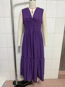Detail view of a solid purple sleeveless V-neck tiered maxi dress on a mannequin