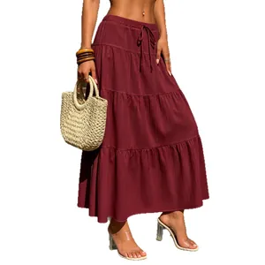 Detail view of burgundy tiered maxi skirt with drawstring waist and textured fabric