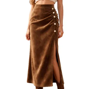 Brown high-waisted suede maxi skirt with elegant side slit and pearl button accents