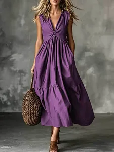 Elegant purple sleeveless V-neck maxi dress with tiered skirt and woven bag