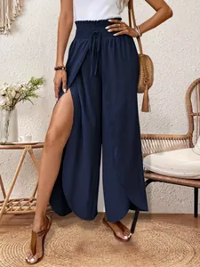 Detail of navy blue high-waisted wide-leg trousers with elegant high side slits design.