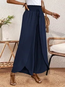 Elegant navy blue split leg palazzo pants with a high smocked waist shown on a model.