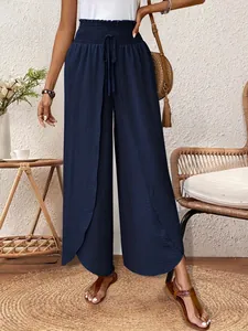 Detailed view of navy blue high-waisted wide-leg pants with an elegant split design