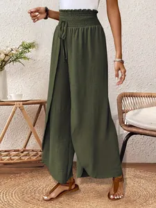 Detailed view of olive green wide-leg trousers featuring an elegant wrap slit design.