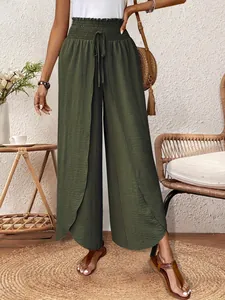 Detail of olive green wide-leg pants featuring a unique split tulip hem design.