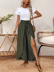 Detailed macro view of olive green high-waist trousers featuring a stylish high side slit.