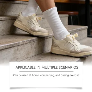 Detailed lifestyle view of cream sneakers on stone stairs for deodorant spray scenario