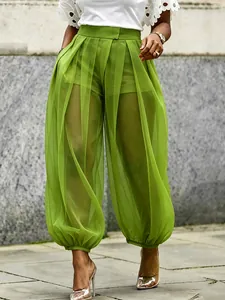 Close-up of high-waist green mesh sheer lantern pants with stylish layered design