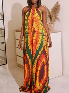 Vibrant bohemian tie-dye halter maxi dress with warm orange and yellow patterns