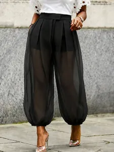 Stylish high-waisted black sheer mesh lantern pants with inner shorts for a chic look.