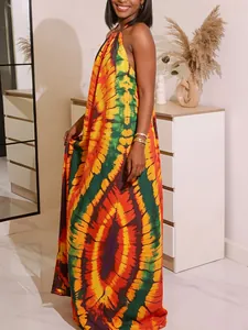 Close-up of vibrant bohemian tie-dye print on a backless halter neck maxi dress
