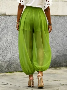 Detailed back view of high waisted lime green mesh sheer wide leg harem pants for summer
