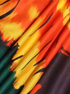 Detailed macro view of vibrant bohemian floral print fabric showing pleated texture