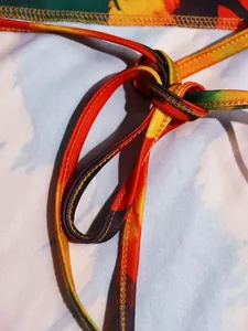 Detail of the adjustable halter strap knot on a Bohemian printed summer dress.
