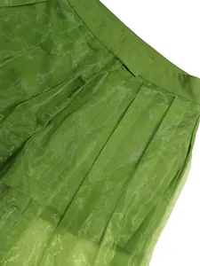 Detail view of high waist green mesh transparent lantern pants showing fabric texture