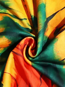 Macro view of vibrant bohemian floral print fabric texture for a summer holiday dress