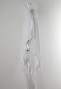Detailed side view of white knit crochet beach cover-up featuring elegant tassel fringe