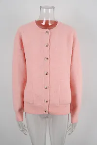 Detailed view of soft pink knitted cardigan with round neck and decorative buttons.