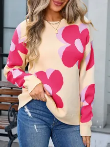 Close-up of woman wearing cream round neck sweater with large pink floral pattern