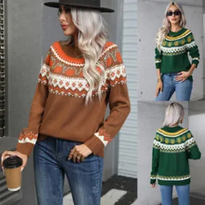 Detailed view of women's pullover sweater featuring geometric prints in brown and green