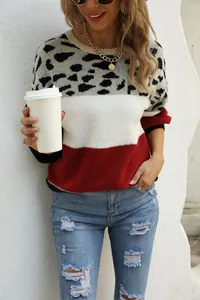 Detail of women's patchwork leopard print crewneck sweater with color-blocking design