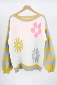 Detailed view of a colorful oversized sweater with flower patterns and striped sleeves.