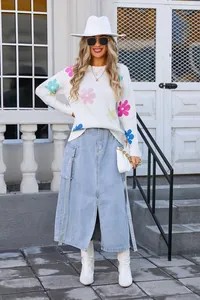 Full length view of a white crew neck knit sweater with vibrant colorful flower patterns