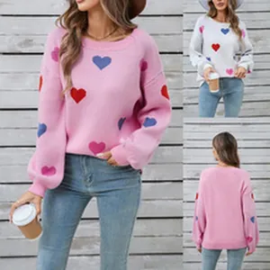 Details of women's heart print knit sweater showing pink, white colors and back view.