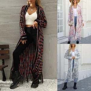Detail view of colorful long knit cardigan with fringe hem and open front design