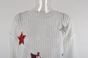 Dettaglio ravvicinato del copricostume bianco traforato con stelle di paillettes