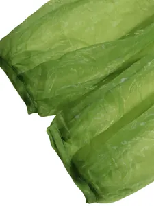 Close-up detail of sheer green mesh fabric showing the texture of the lantern pants hem