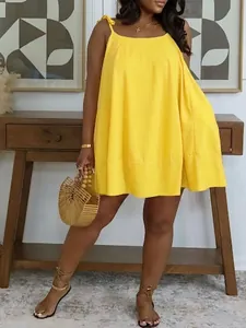 Model wearing yellow loose summer babydoll dress with square neck and tie straps