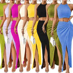 Elegant two-piece vacation set featuring a halter crop top and pleated slit maxi skirt