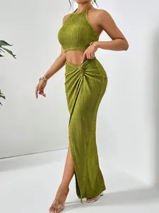 Elegant olive green pleated two-piece set featuring a halter crop top and a slit maxi skirt.