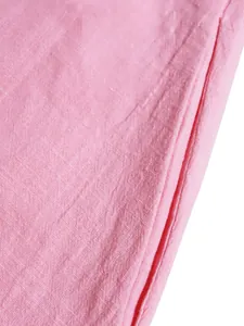 Macro view of pink linen-like fabric texture and side pocket detail on summer dress