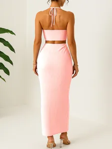 Back view of pink textured two-piece set with halter crop top and maxi skirt for vacation