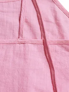 Close-up view of the breathable pink fabric texture and fine stitching on a strap dress