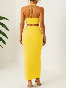 Back view of yellow crinkled two-piece set featuring halter top and maxi skirt