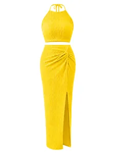 Detailed view of yellow pleated two-piece set with halter top and slit maxi skirt