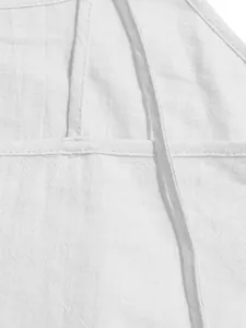 Close-up of white breathable fabric and stitching on a summer spaghetti strap dress