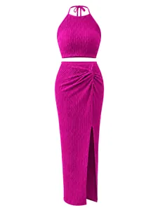 Detailed view of magenta plissé pleated two-piece set with halter top and slit skirt