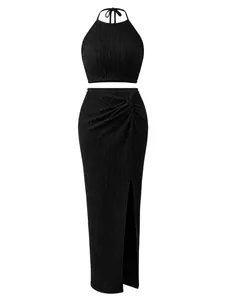 Elegant black two-piece pleated set with halter crop top and high-slit maxi skirt