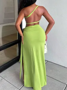 Back view of a sexy lime green one-shoulder two-piece maxi dress with a high side slit