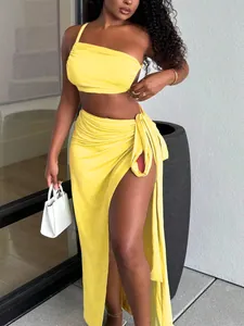 Vibrant yellow one-shoulder crop top and high-slit maxi skirt two-piece set for summer