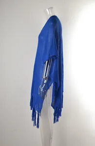 Detailed side view of a royal blue hollow out knit beach cover up with stylish tassels.