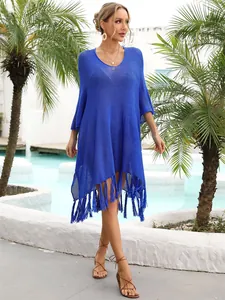 Vibrant blue hollow knit beach cover-up with long tassel hem and relaxed V-neck design