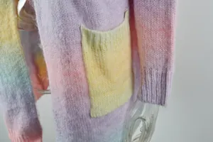 Close-up of rainbow tie-dye knit texture and functional pocket on loose cardigan