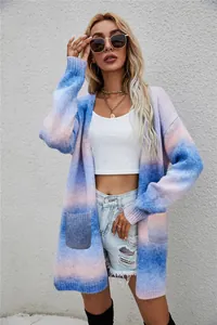 Full length view of a loose rainbow tie-dye long knit cardigan on a model outdoors