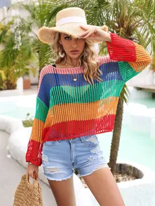 Outdoor resort detail of rainbow crochet cover-up with long sleeves for beach sun protection